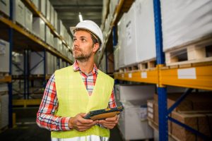 Man in a warehouse in checking inventory levels of goods. First in first out, Last in last out concept photoMan in a warehouse in checking inventory levels of goods. First in first out, Last in last out, just in time, delivery, storage concept photo.